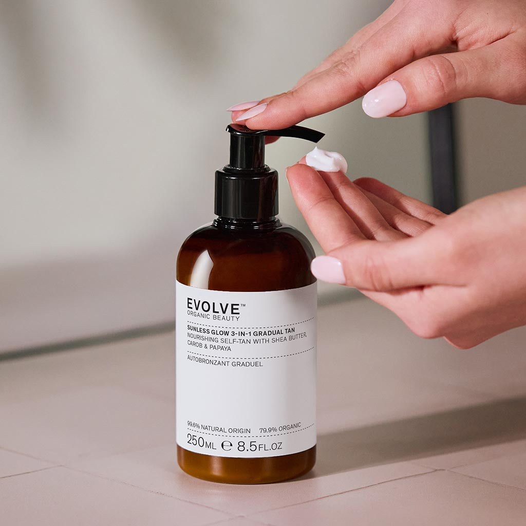 Hand dispensing Evolve Sunless Glow gradual tanning product